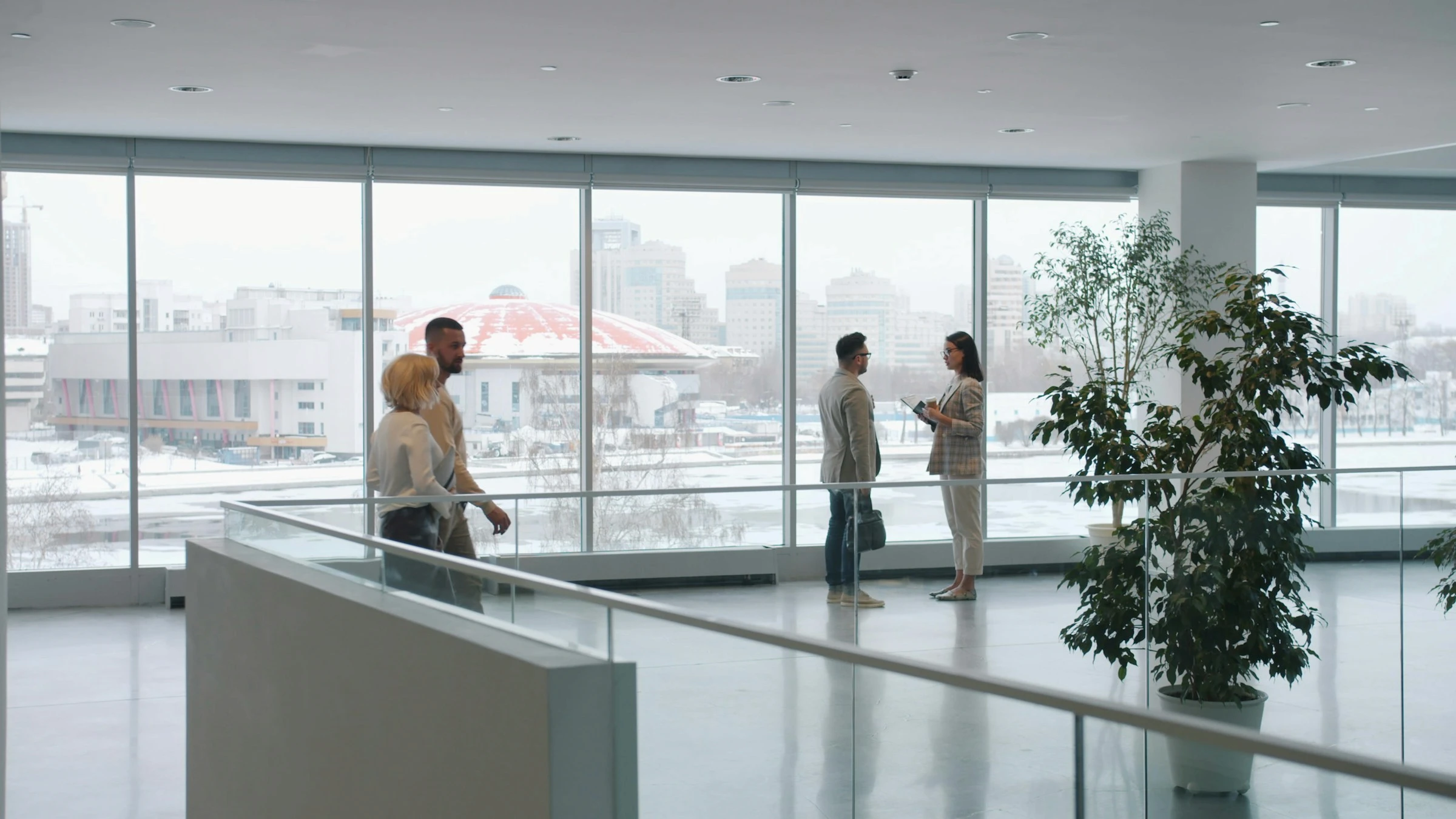 People in conversation within a bright architectural setting