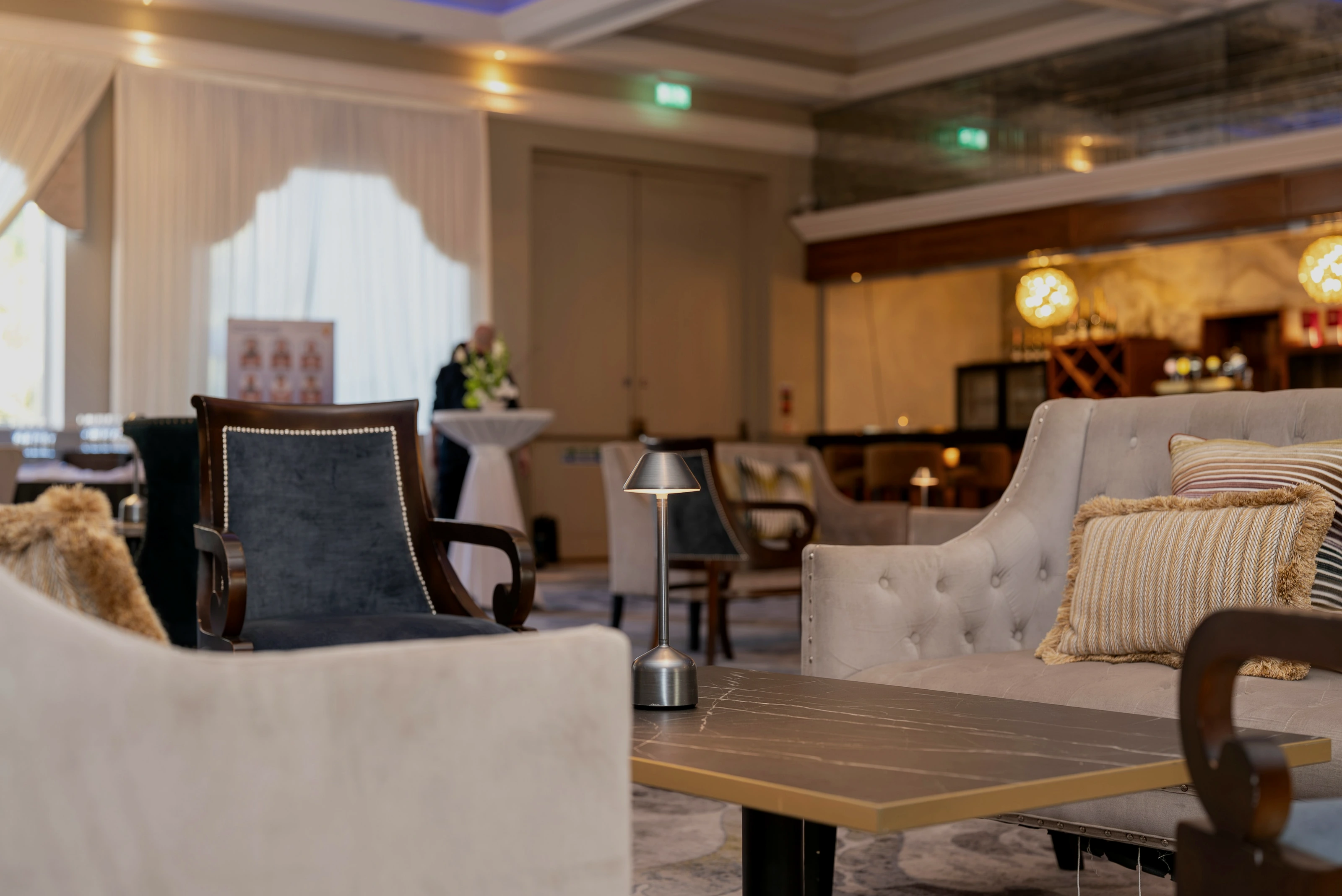 A quiet premium lounge with soft lighting and comfortable seating